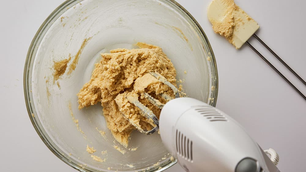 mixing cookie dough with hand mixer