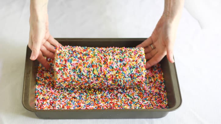 rolling cake in sprinkles