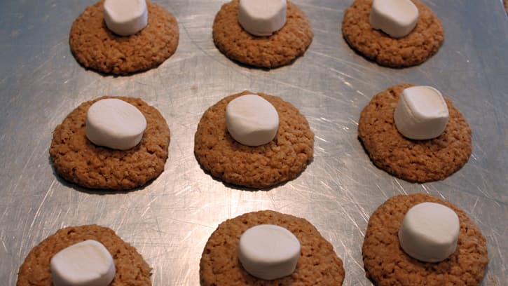 half marshmallows on top of baked cookies