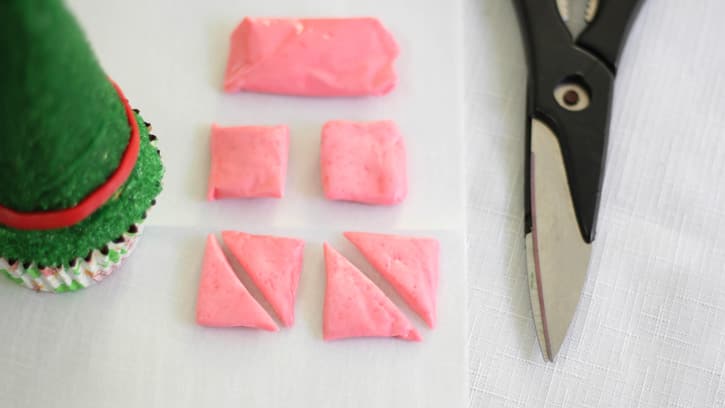 cutting pink taffy into small triangles