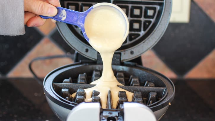 pouring batter into waffle maker