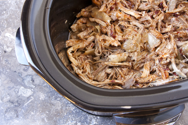 mixing sauce with shredded pork