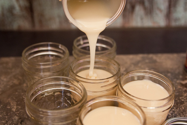 pouring sweetened condensed milk in jars