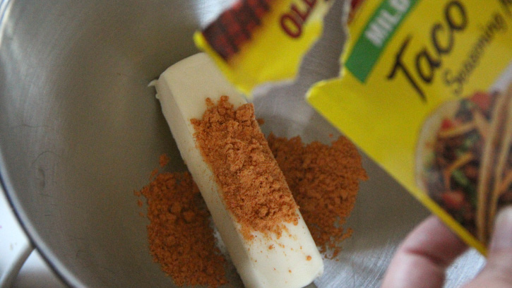 adding taco seasoning to butter