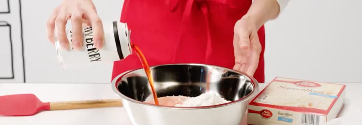 Pouring a can of soda into a mixing bowl
