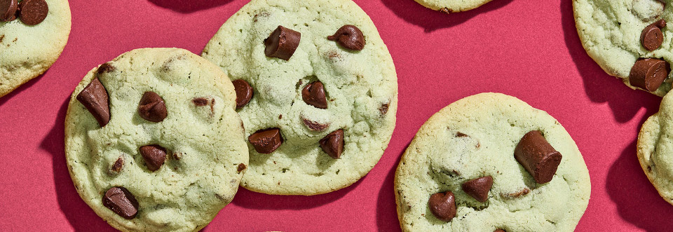 Top down image of Mint Chocolate Chip cookies on a red background.