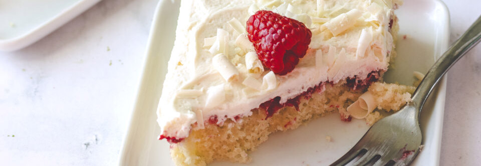 Top down image of White Chocolate Poke Cake on white background. 