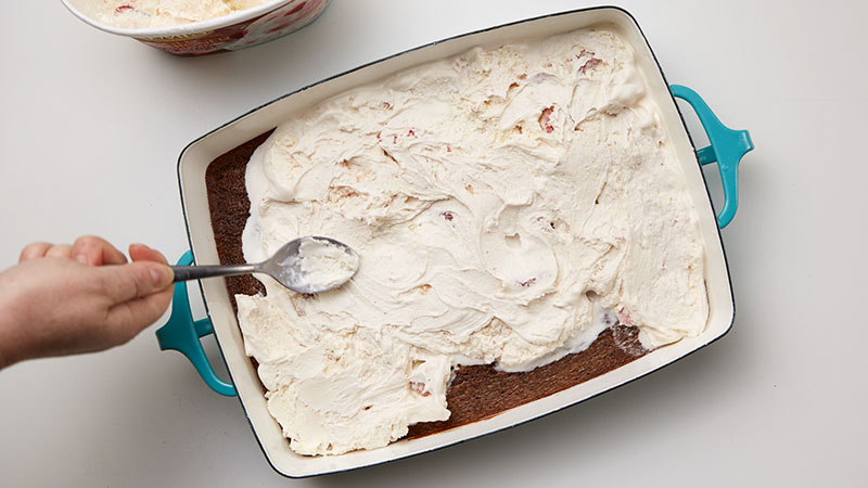 soften six cups of strawberry ice cream, so you can spread it on top of the brownie base