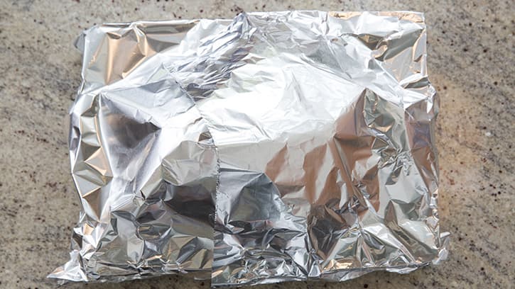 Turkey covered with aluminum foil and ready to dry brine
