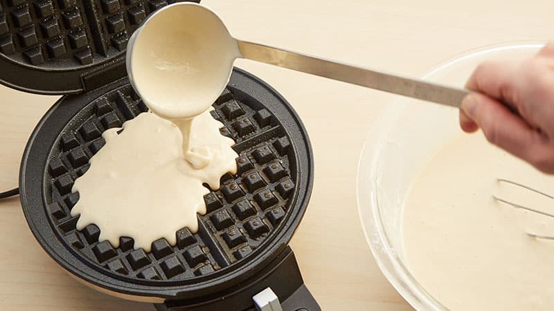 pour waffle batter on waffle iron