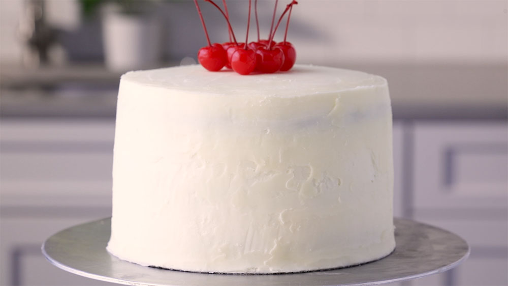 frosted cake with cherry on top