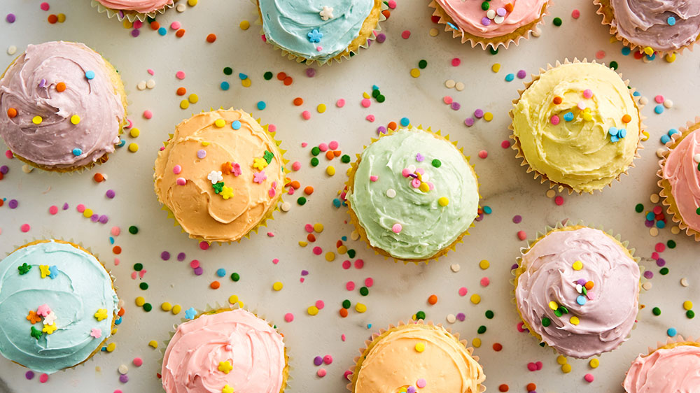 Pastel frosted cupcakes with sprinkles 