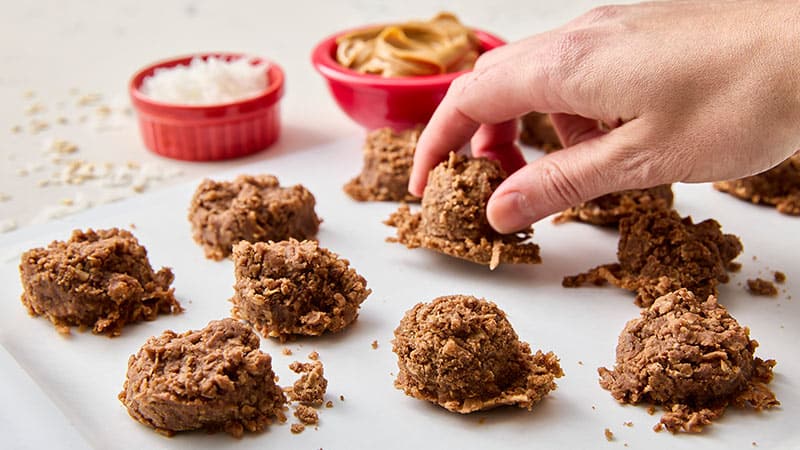 No bake chocolate oatmeal cookies being placed on a tray