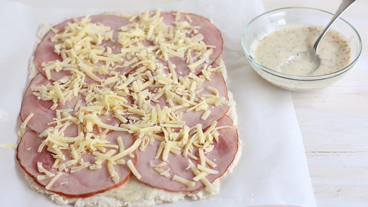 ham and cheese on top of dough