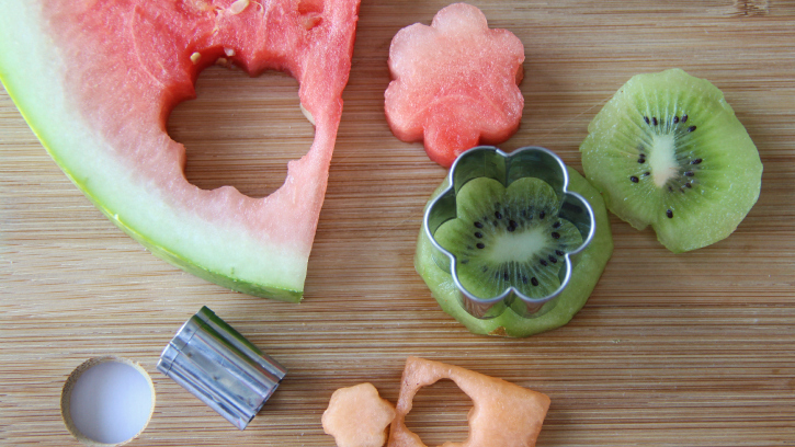 cutting out fruit with shaped cookie cutters