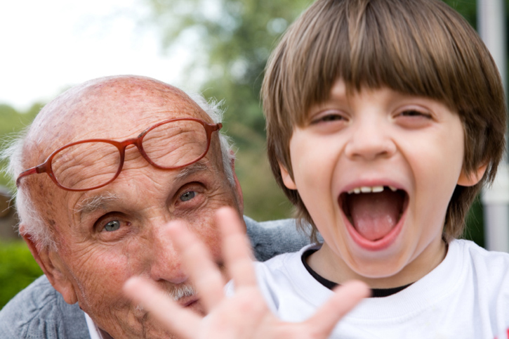 smiling child with elderly man