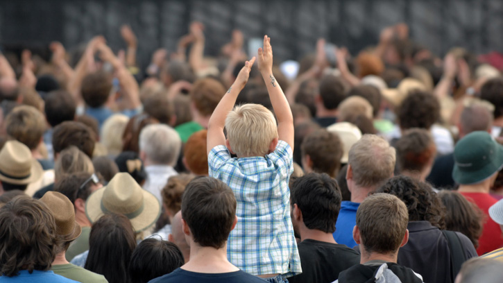 Child cheering at concert