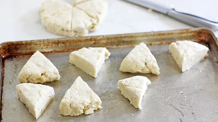 dough cut into triangles on cookie sheet