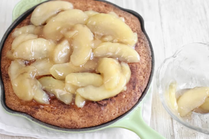 spreading apples on top of baked cookie