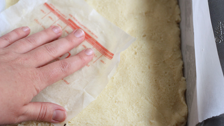 pressing dough into pan