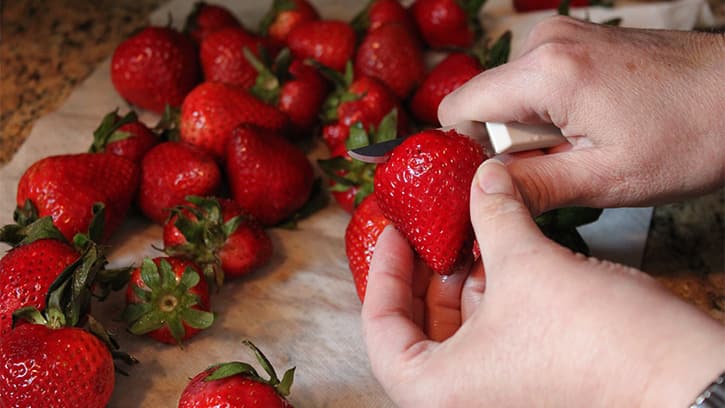 cutting fresh strawberries