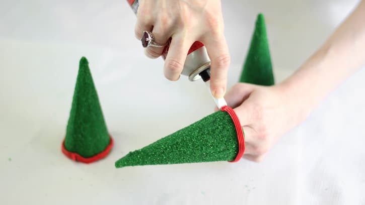 frosting bottom rim of green cones with red frosting