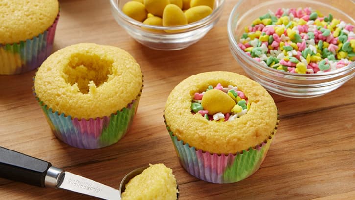 filling baked cupcakes with candy