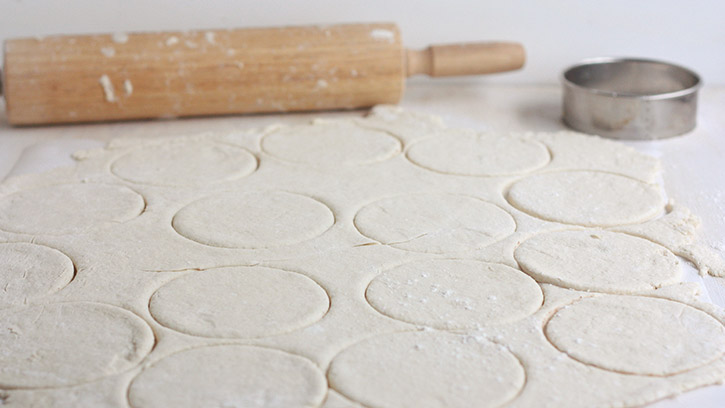 rolled dough with circles cut in
