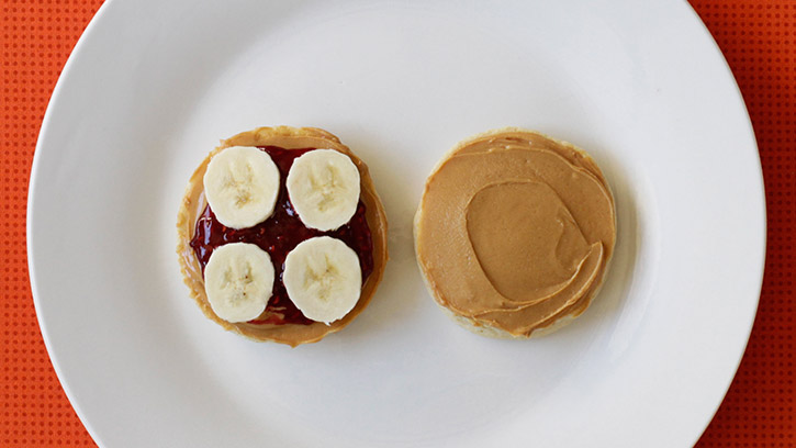 Peanut butter, jelly and banana sliders open to show ingredients and banana slices