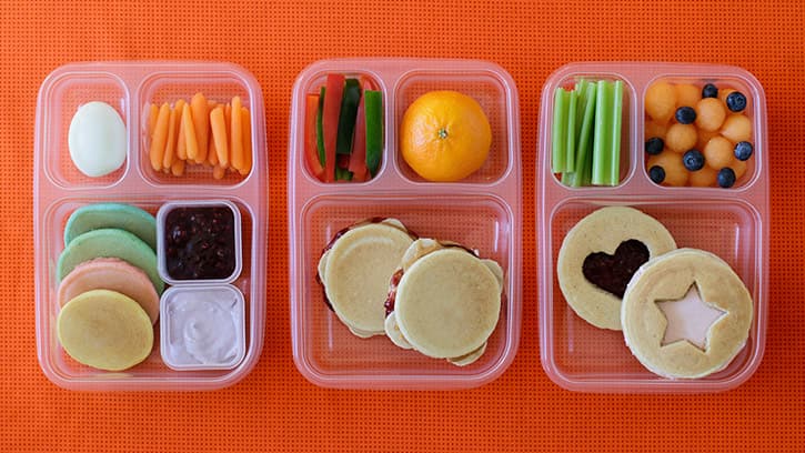 3 compartmented lunch containers with different pancake lunches