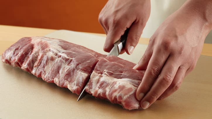 cutting ribs with knife