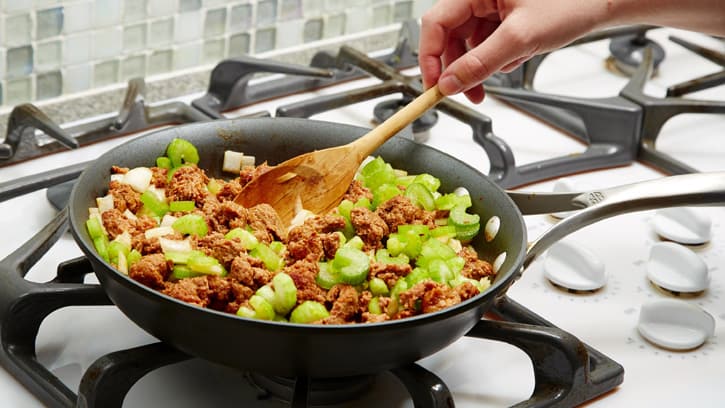 cooking onion, sausage and celery on stovetop