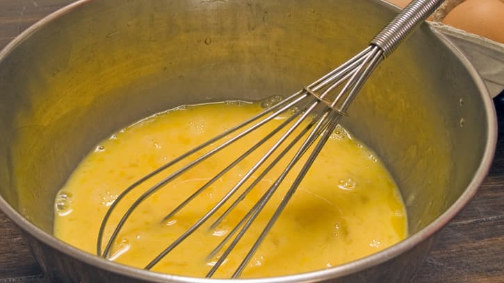 beating eggs with whisk