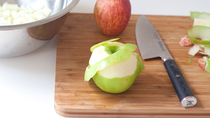 cutting an apple on cutting board