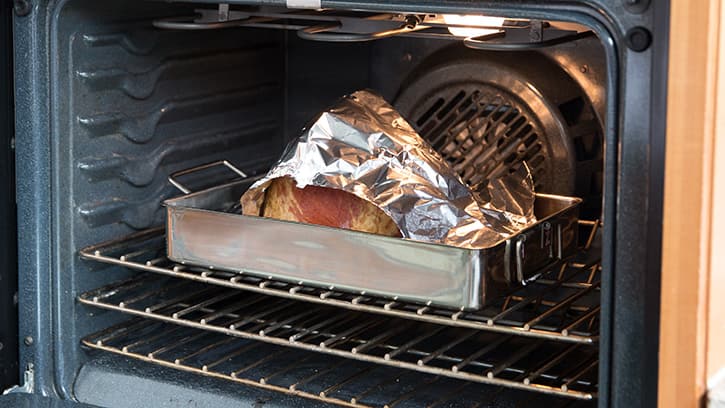 ham in oven tented with foil