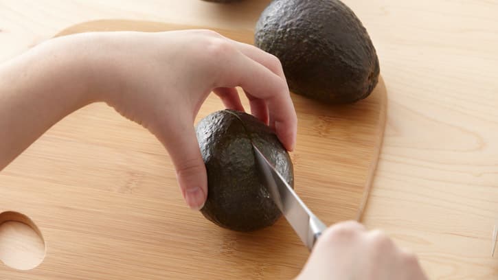 cutting into avocado