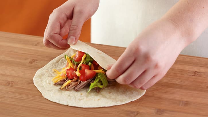folding one end of a burrito