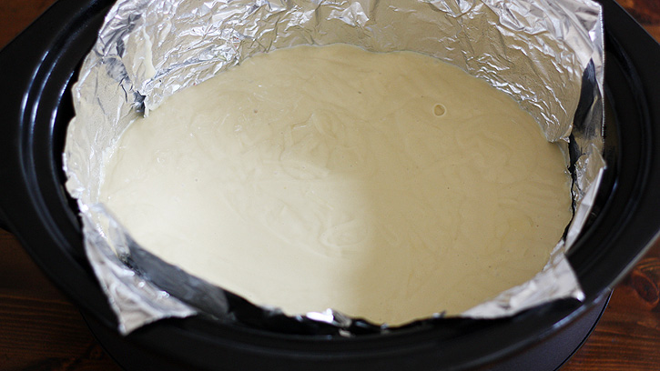 cake batter poured in slow cooker